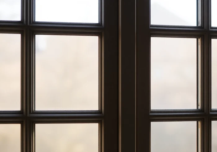 Secondary glazing for sash windows installed within classic wooden frames, enhancing insulation and reducing noise in a stylish home setting for better comfort and energy efficiency.